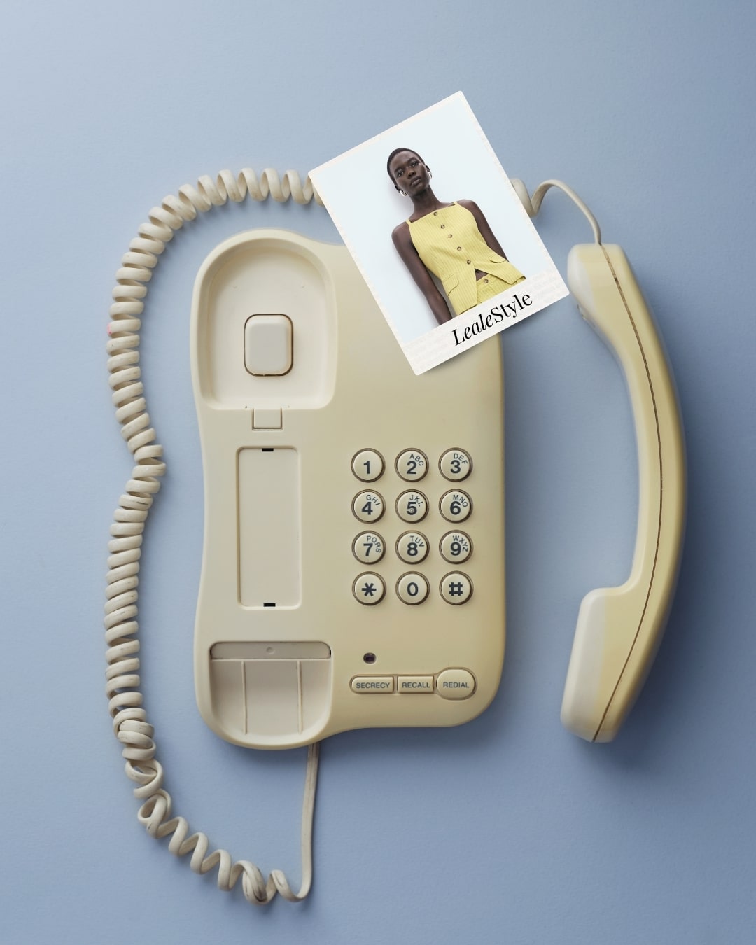 Phone with Polaroid Mango Yellow Striped top and LealeStyle logo