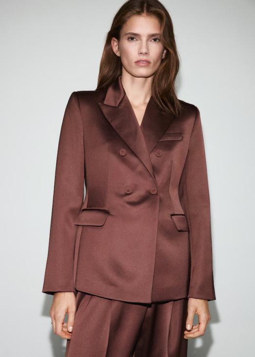 Satin suit jacket styled for textured winter elegance with subtle sheen