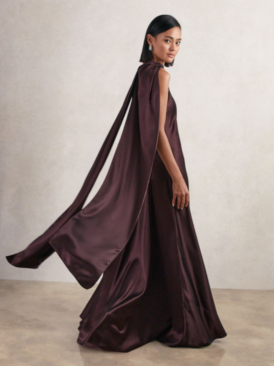 Satin cape maxi dress styled for textured winter elegance and refined winter evenings