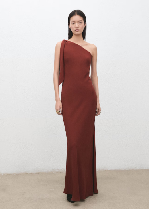 Asymmetrical satin dress styled for understated winter elegance