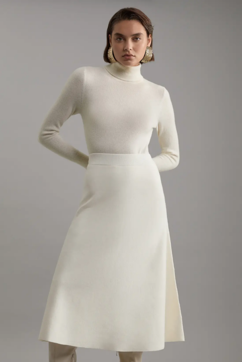 Knit midi skirt in winter white creating fluid movement and elegant coverage