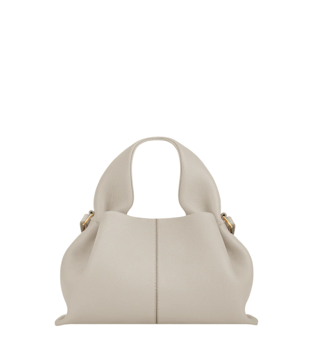 Neutral structured handbag complementing winter white outfits