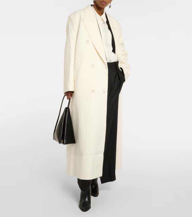 Oversized ivory wool coat creating a clean winter white silhouette
