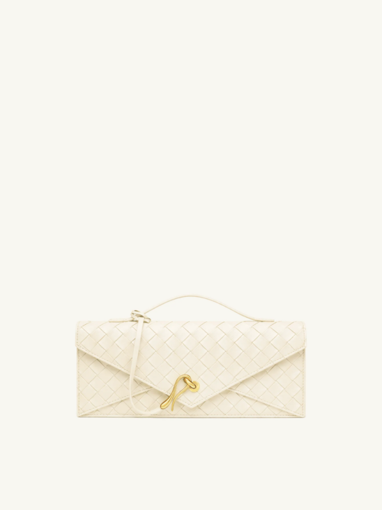 Structured neutral handbag complementing a winter white look
