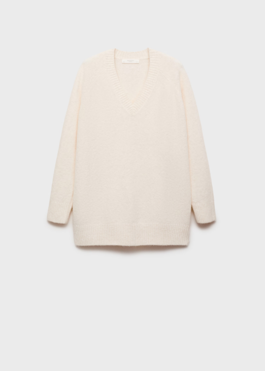 Ivory knit sweater layered for refined winter white styling
