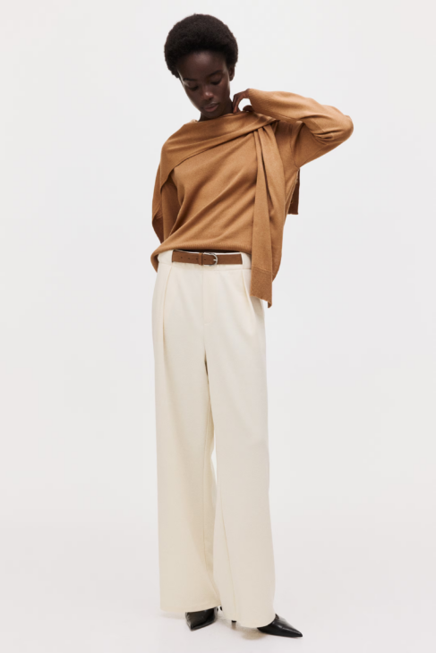 Tailored neutral trousers creating clean lines in winter white outfits